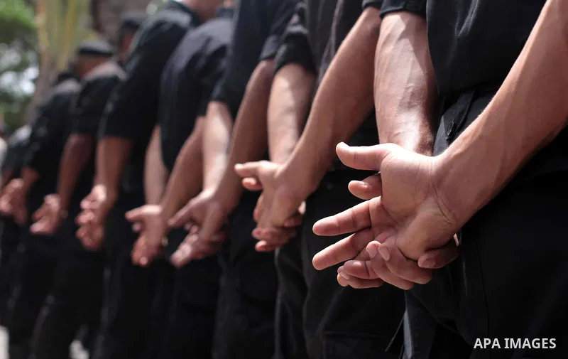 Palestinian policemen stand guard in front of the United Nations Development Programme office (UNDP), during a protest calling for the release of Palestinian prisoners from Israeli jails, in Gaza City on May 07, 2014. Ph...