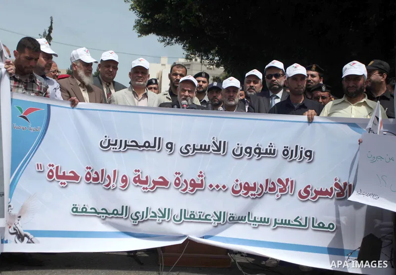 Palestinians hold placards during a protest calling for the release of Palestinian prisoners from Israeli jails, in front of the United Nations Development Programme office (UNDP) in Gaza City on May 07, 2014. Photo by A...