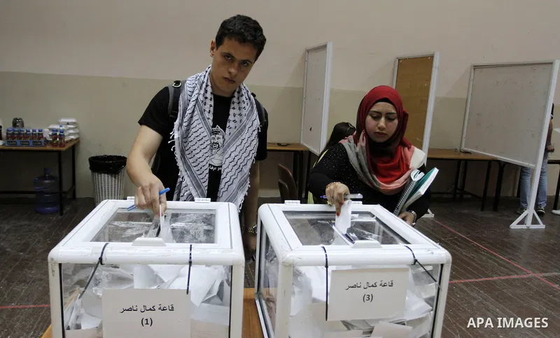 Palestinian students of BirZeit University cast their ballots during the Student Council elections, on the outskirts of the city of Ramallah in the West Bank on May 7, 2014. The Student Council elections, will pit studen...