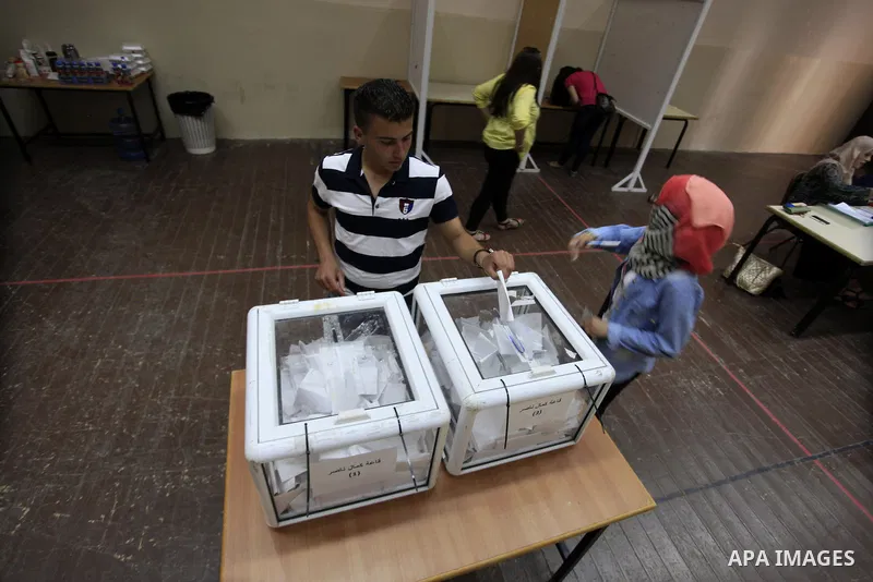 Palestinian students of BirZeit University cast their ballots during the Student Council elections, on the outskirts of the city of Ramallah in the West Bank on May 7, 2014. The Student Council elections, will pit studen...