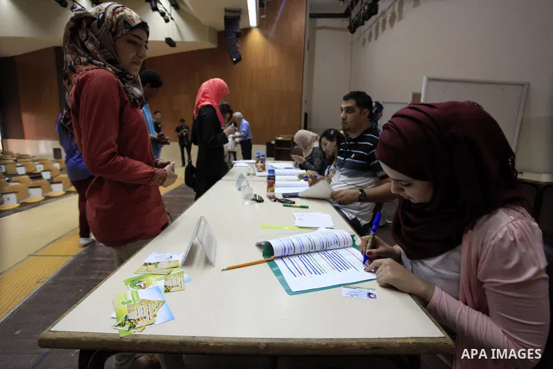 Electoral commission employees count votes during the Student Council elections at BirZeit University, on the outskirts of the city of Ramallah in the West Bank on May 7, 2014. The Student Council elections, will pit stu...
