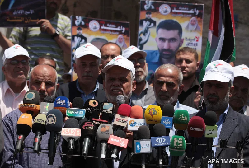 Palestinians take part a protest in solidarity with Palestinian prisoners on hunger strike in Israeli jails, in front of the International Committee of the Red Cross' Gaza office in Gaza City on May 10, 2014 About 5,000...