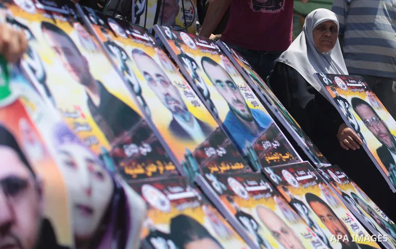 Palestinians take part a protest in solidarity with Palestinian prisoners on hunger strike in Israeli jails, in front of the International Committee of the Red Cross' Gaza office in Gaza City on May 10, 2014 About 5,000...