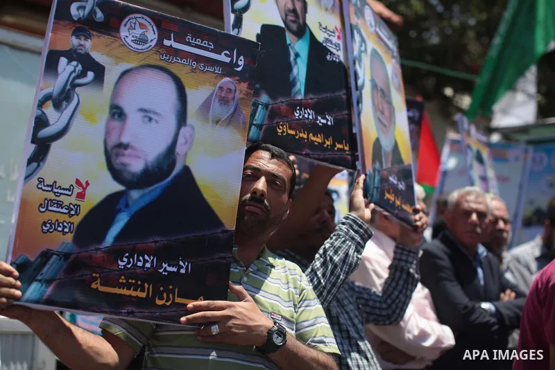 Palestinians take part a protest in solidarity with Palestinian prisoners on hunger strike in Israeli jails, in front of the International Committee of the Red Cross' Gaza office in Gaza City on May 10, 2014 About 5,000...