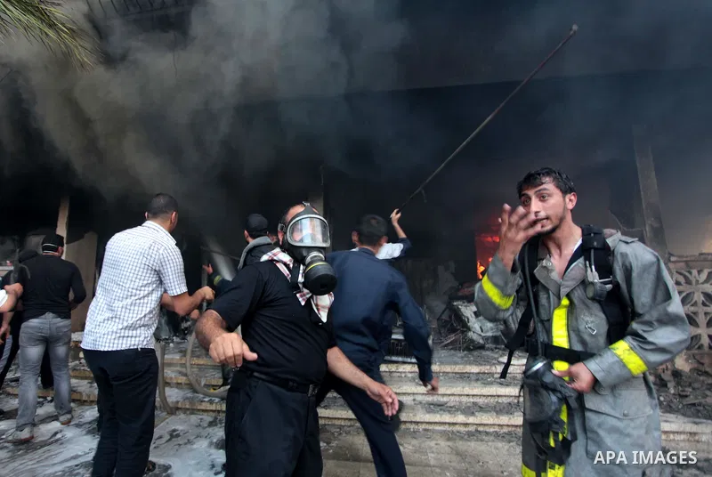 Palestinian firefighters try to extinguish a fire after a fire swept over a store of Electrical appliances in Gaza city on May 10, 2014. Photo by Ashraf Amra
