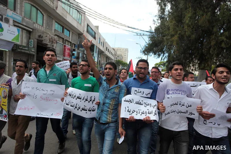Palestinian protesters hold placards during a rally demanding the release of Palestinian prisoners on hunger strike held in Israeli jails, in Gaza City, 12 May 2014. According to reports, more than 5,000 Palestinians are...
