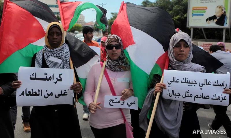 Palestinian protesters hold placards during a rally demanding the release of Palestinian prisoners on hunger strike held in Israeli jails, in Gaza City, 12 May 2014. According to reports, more than 5,000 Palestinians are...