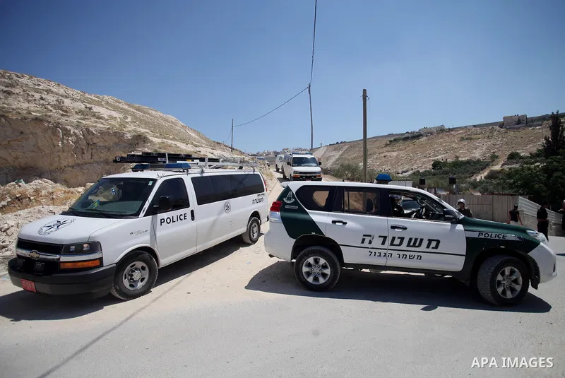 Israeli policemen stand guard as municipality bulldozers demolish a Palestinian house under the pretext of building without permit, at Jabal al-Mukaber district, East Jerusalem May 14, 2014. Israel destroyed more than 50...