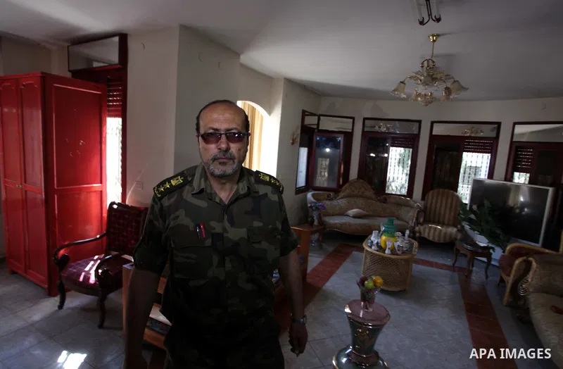 A member of the Palestinian security forces loyal to Hamasinspects the house of Palestinian president Mahmoud Abbas in Gaza City May 14, 2014, as they prepare to handover the house which Hamas seized during a brief civil...