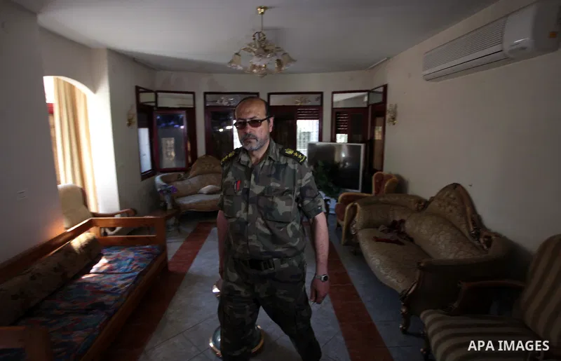 A member of the Palestinian security forces loyal to Hamasinspects the house of Palestinian president Mahmoud Abbas in Gaza City May 14, 2014, as they prepare to handover the house which Hamas seized during a brief civil...
