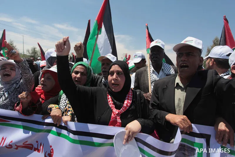 Palestinian protesters take part in a rally marking the Nakba or the ''Day of Catastrophe'' near Erez crossing in the northern Gaza Strip on May 15, 2014. Palestinians marked "Nakba" (Catastrophe) on Thursday to commemor...