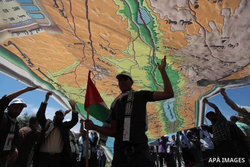 Palestinian protesters take part in a rally marking the Nakba or the ''Day of Catastrophe'' near Erez crossing in the northern Gaza Strip on May 15, 2014. Palestinians marked "Nakba" (Catastrophe) on Thursday to commemor...