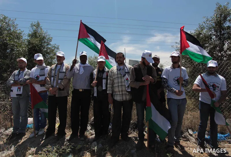 Palestinian protesters take part in a rally marking the Nakba or the ''Day of Catastrophe'' near Erez crossing in the northern Gaza Strip on May 15, 2014. Palestinians marked "Nakba" (Catastrophe) on Thursday to commemor...