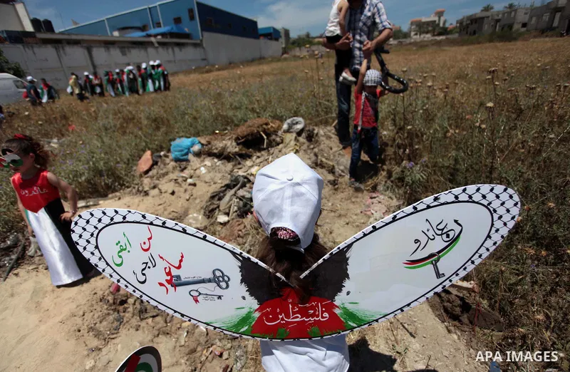 Palestinian protesters take part in a rally marking the Nakba or the ''Day of Catastrophe'' near Erez crossing in the northern Gaza Strip on May 15, 2014. Palestinians marked "Nakba" (Catastrophe) on Thursday to commemor...