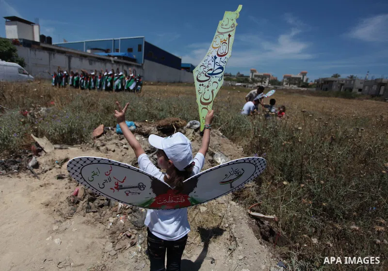 Palestinian protesters take part in a rally marking the Nakba or the ''Day of Catastrophe'' near Erez crossing in the northern Gaza Strip on May 15, 2014. Palestinians marked "Nakba" (Catastrophe) on Thursday to commemor...