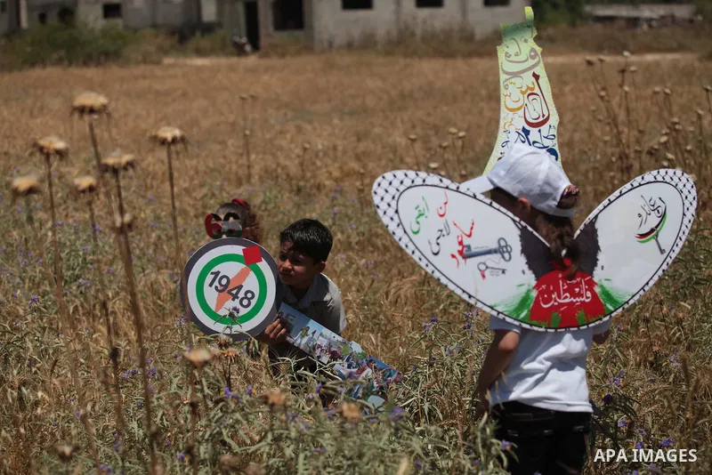 Palestinian protesters take part in a rally marking the Nakba or the ''Day of Catastrophe'' near Erez crossing in the northern Gaza Strip on May 15, 2014. Palestinians marked "Nakba" (Catastrophe) on Thursday to commemor...