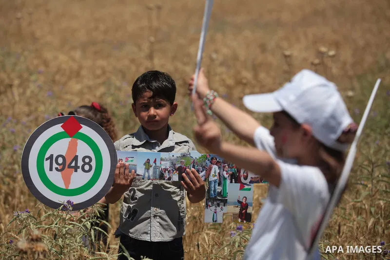 Palestinian protesters take part in a rally marking the Nakba or the ''Day of Catastrophe'' near Erez crossing in the northern Gaza Strip on May 15, 2014. Palestinians marked "Nakba" (Catastrophe) on Thursday to commemor...