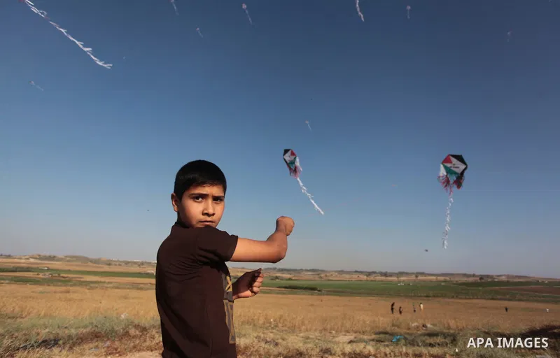 A Palestinian child flies kites to mark the Nakba or the ''Day of Catastrophe'' in Beit Hanoun in the northern Gaza Strip, on May 17, 2014.Palestinians marked ''Nakba'' to commemorate the expulsion or fleeing of some 700...