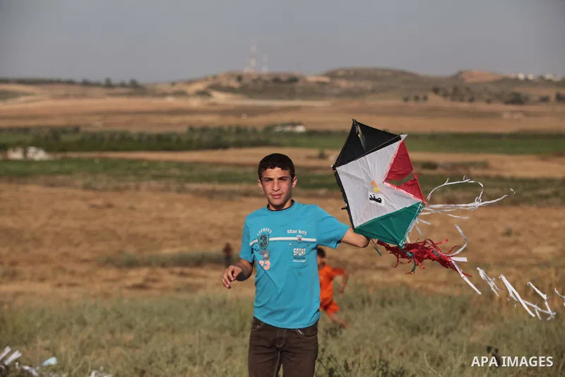 A Palestinian child flies kites to mark the Nakba or the ''Day of Catastrophe'' in Beit Hanoun in the northern Gaza Strip, on May 17, 2014.Palestinians marked ''Nakba'' to commemorate the expulsion or fleeing of some 700...