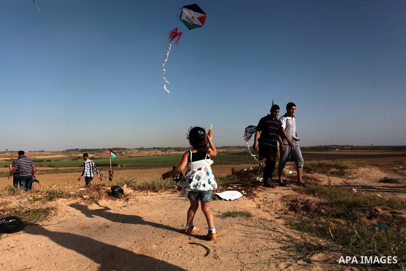 A Palestinian child flies kites to mark the Nakba or the ''Day of Catastrophe'' in Beit Hanoun in the northern Gaza Strip, on May 17, 2014.Palestinians marked ''Nakba'' to commemorate the expulsion or fleeing of some 700...