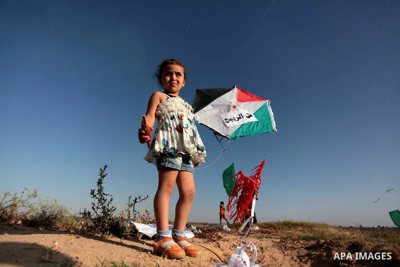 A Palestinian child flies kites to mark the Nakba or the ''Day of Catastrophe'' in Beit Hanoun in the northern Gaza Strip, on May 17, 2014.Palestinians marked ''Nakba'' to commemorate the expulsion or fleeing of some 700...
