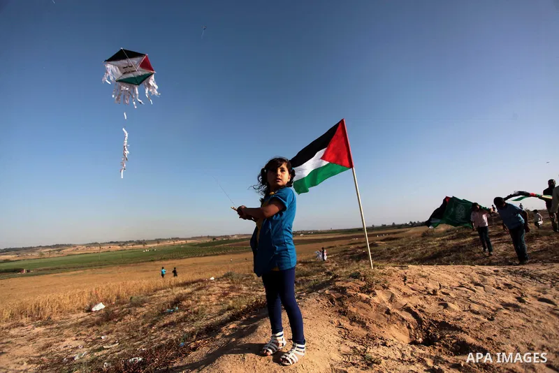 A Palestinian child flies kites to mark the Nakba or the ''Day of Catastrophe'' in Beit Hanoun in the northern Gaza Strip, on May 17, 2014.Palestinians marked ''Nakba'' to commemorate the expulsion or fleeing of some 700...