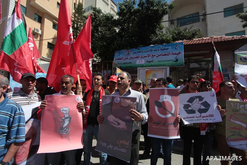 Palestinians take part a protest during a rally in Gaza City on May 18, 2014 to express solidarity with Palestinian prisoners on hunger strike in Israeli jails. In late March, Israel had refused to release as promised a...