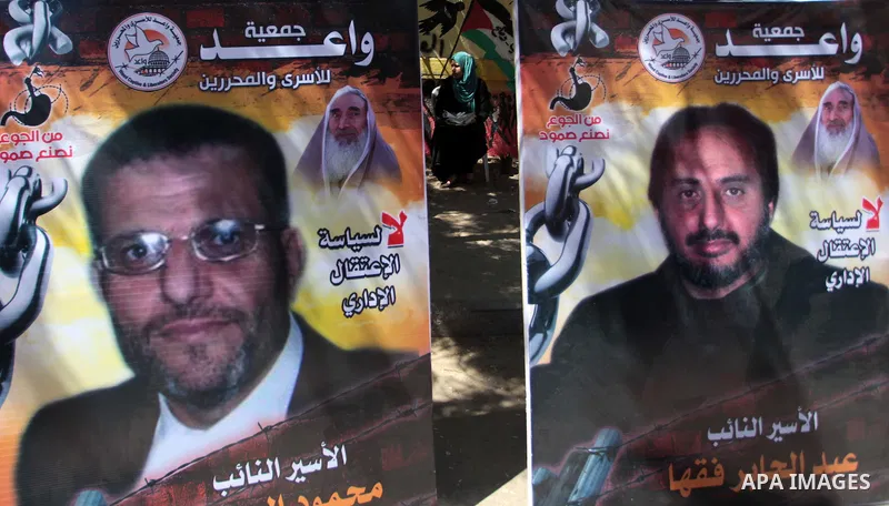Palestinians take part a protest during a rally in Gaza City on May 18, 2014 to express solidarity with Palestinian prisoners on hunger strike in Israeli jails. In late March, Israel had refused to release as promised a...