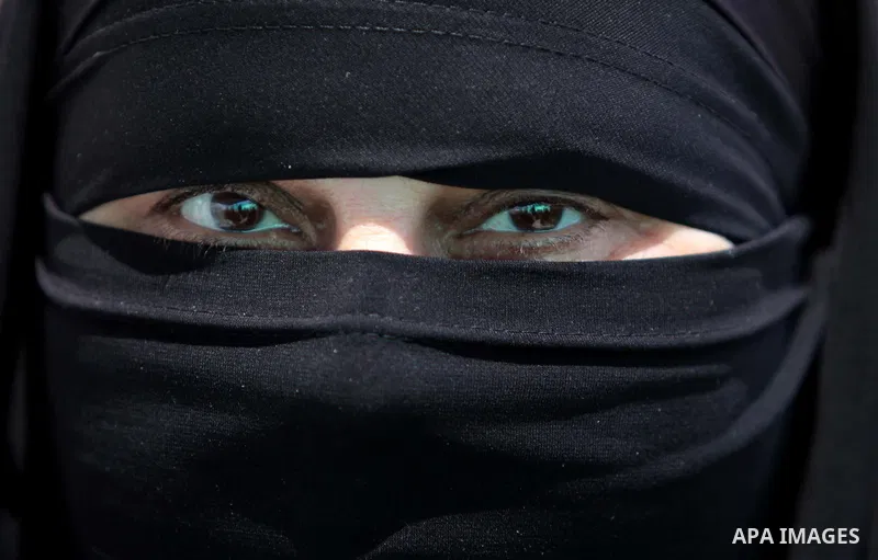 A Palestinian woman poses for a picture during a protest against the Judaization of Al-Aqsa at the Legislative Council in Gaza City on May 18, 2014. Photo by Ashraf Amra