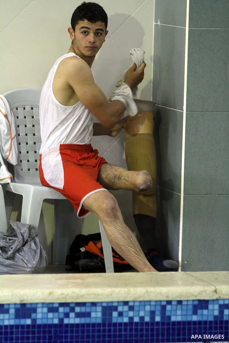 Palestinian Motasim Abu Karsh, 17, rests after swimming in a pool at a club in Gaza City May 18, 2014. Abu Karsh lost his leg after he was injured during an Israeli air strike in 2005. He won the first place in the frees...