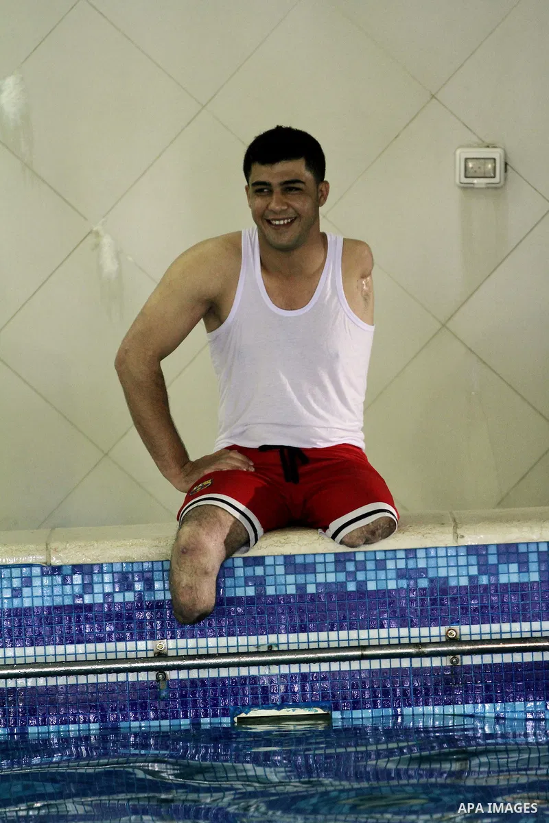 Palestinian Asaad al-Zaneen, 21, rests after swimming in a pool at a club in Gaza City May 18, 2014. Al-Zaneen lost his leg after he was injured by an Israeli tank shell in 2007. He won the first place in the 50 meter sw...