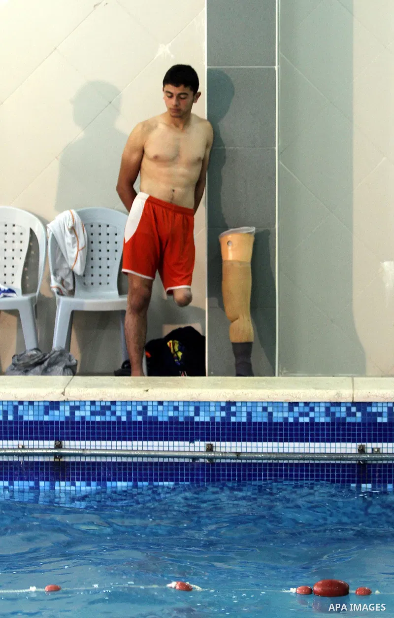 Palestinian Motasim Abu Karsh, 17, rests after swimming in a pool at a club in Gaza City May 18, 2014. Abu Karsh lost his leg after he was injured during an Israeli air strike in 2005. He won the first place in the frees...