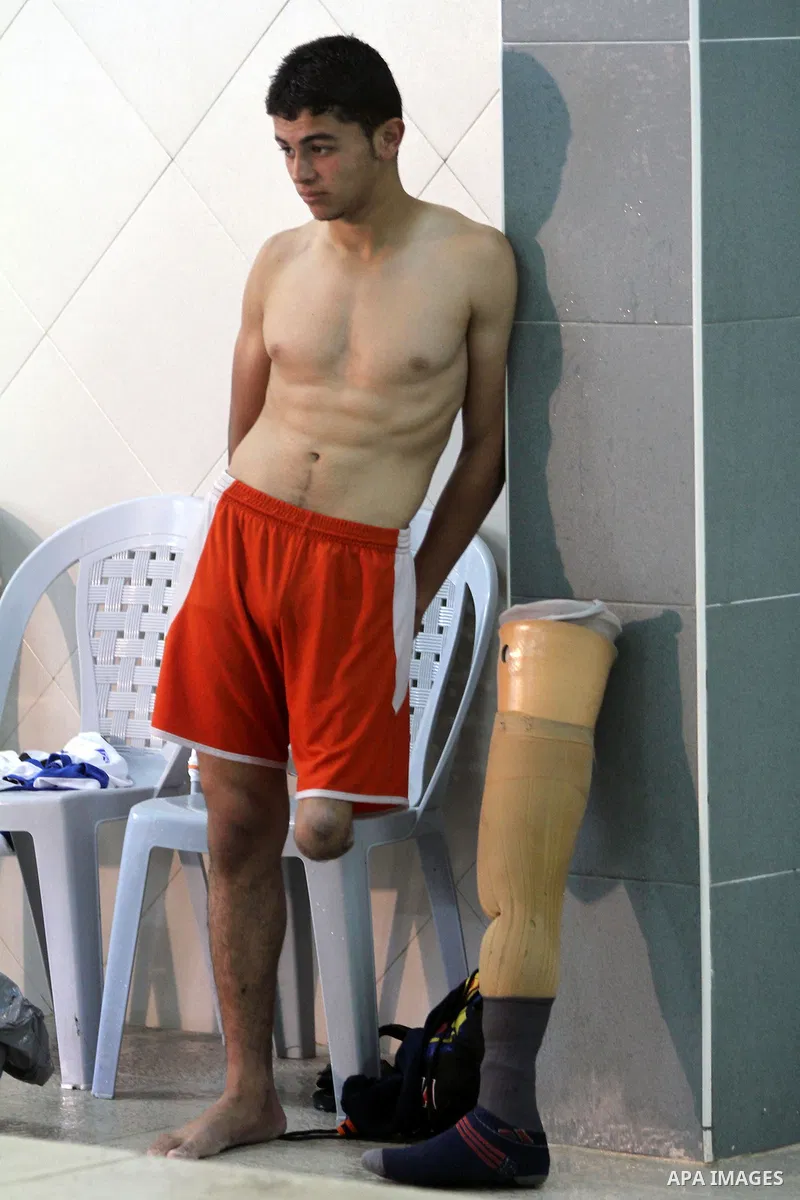 Palestinian Motasim Abu Karsh, 17, rests after swimming in a pool at a club in Gaza City May 18, 2014. Abu Karsh lost his leg after he was injured during an Israeli air strike in 2005. He won the first place in the frees...