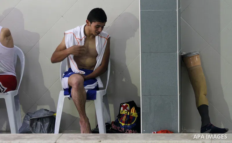 Palestinian Motasim Abu Karsh, 17, rests after swimming in a pool at a club in Gaza City May 18, 2014. Abu Karsh lost his leg after he was injured during an Israeli air strike in 2005. He won the first place in the frees...