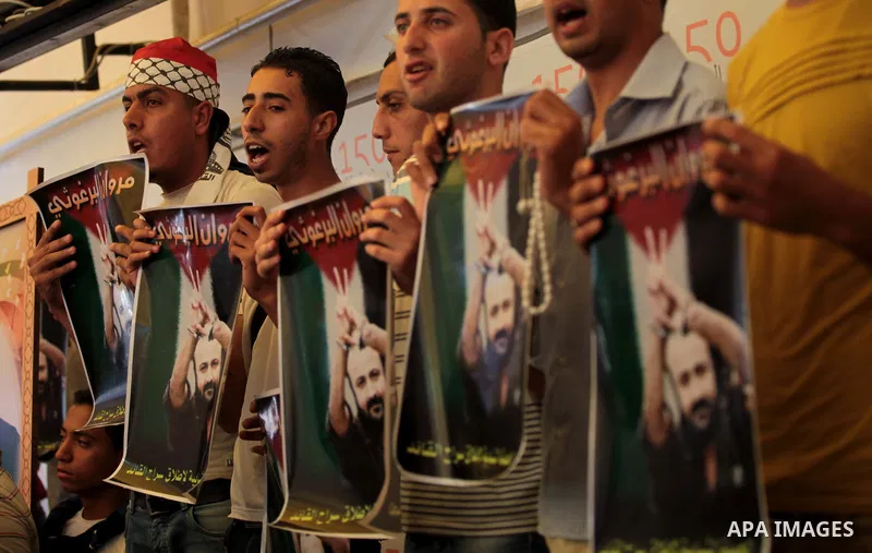 Palestinians attend a weekly protest at the Red Cross office in Gaza City on May 19, 2014, to express solidarity with Palestinian prisoners on hunger strike in Israeli jails. In late March, Israel had refused to release...