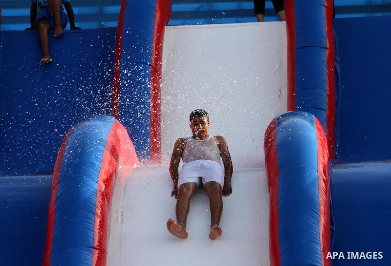 Palestinian children slide down a huge water slide at Aqua Park, in Gaza City May 22, 2014. Photo by Mohammed Asad