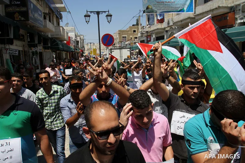 Palestinians take part a protest to solidarity with Palestinian prisoners held in Israeli jails, in the West Bank city of Tulkarem on May 24, 2014. Some 120 Palestinians jailed without trial in Israel have been on an ope...
