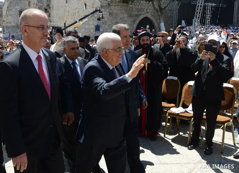 Palestinian President Mahmoud Abbas attends an open-air mass led by Pope Francis (not pictured), in the Manger Square, next the Nativity Church, in the West Bank city of Bethlehem, 25 May 2014. Pope Francis arrived in th...