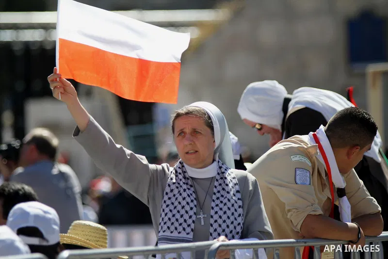 Worshipers attend an open-air mass led by Pope Francis (not pictured), in the Manger Square, next the Nativity Church, in the West Bank city of Bethlehem, 25 May 2014. Pope Francis arrived in the West Bank to start the m...