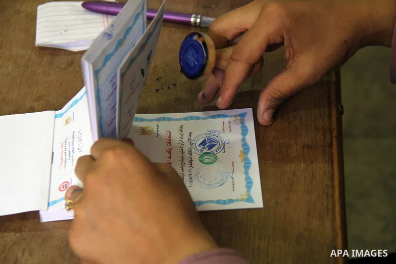 An Electoral worker prepares ballots at a polling station in Cairo on May 26, 2014. Egyptians begin voting in a new presidential election which ex-army chief Abdel Fattah al-Sisi, who ousted the elected Islamist leader,...