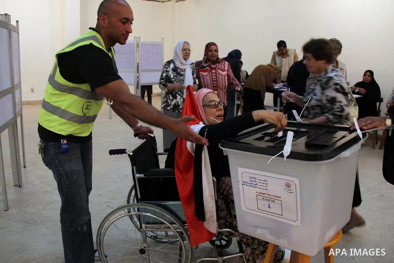 Egyptian women cast their vote at a polling station in Cairo on May 26, 2014. Egyptians begin voting in a new presidential election which ex-army chief Abdel Fattah al-Sisi, who ousted the elected Islamist leader, is exp...