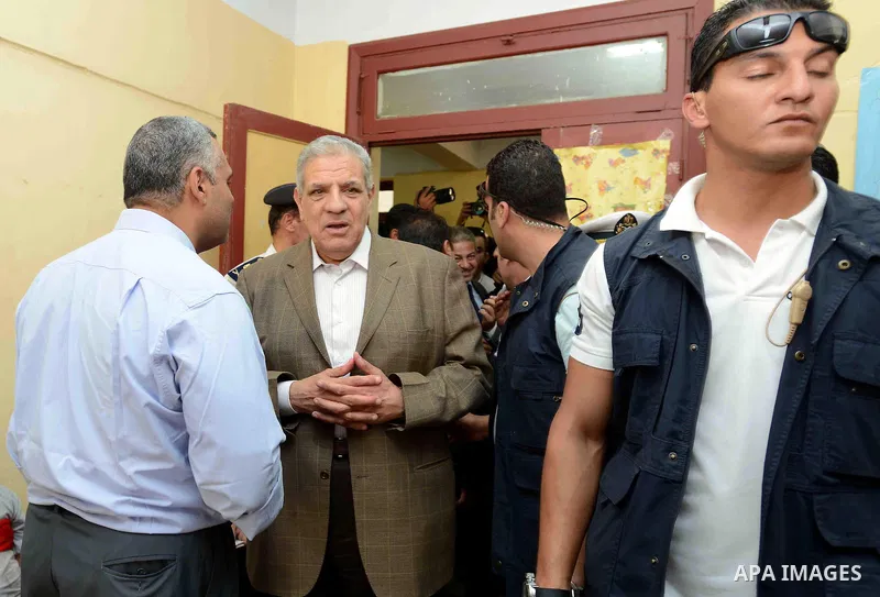 Egypt's interim Prime Minister Ibrahim Mahlab arrives at a polling station to cast his vote during the presidential election in Cairo, Egypt, May 26, 2014. Egyptian voters started casting their ballots on Monday across t...