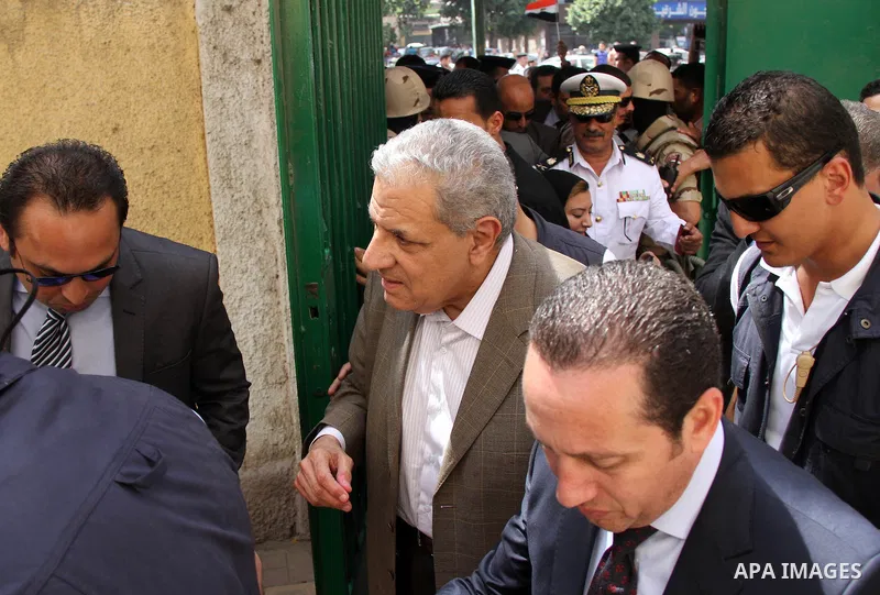 Egypt's interim Prime Minister Ibrahim Mahlab arrives at a polling station to cast his vote during the presidential election in Cairo, Egypt, May 26, 2014. Egyptian voters started casting their ballots on Monday across t...
