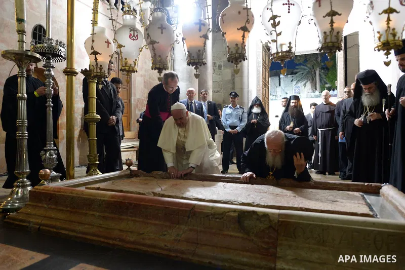 Pope Francis prays at the Church of the Holy Sepulchre in the Old City of Jerusalem on May 25, 2014. In his first Middle East tour since his anointment in 2013, Pope Francis held a historic prayer service with the Ecumen...