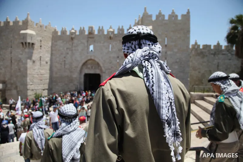 Palestinian scouts play musical instruments as they parade through the streets during a ceremony commemorating the Islamic holiday of Isra Mi'raj, at the Al-Aqsa mosque compound in the Old City of Jerusalem on May 26, 20...