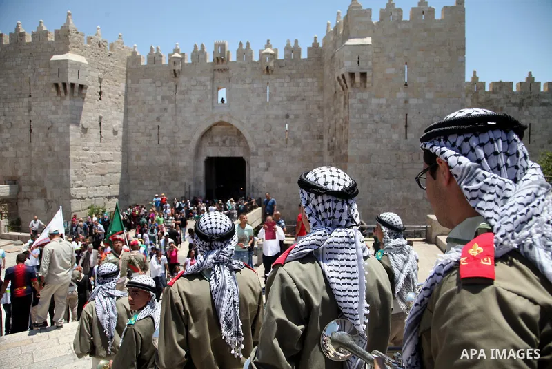 Palestinian scouts play musical instruments as they parade through the streets during a ceremony commemorating the Islamic holiday of Isra Mi'raj, at the Al-Aqsa mosque compound in the Old City of Jerusalem on May 26, 20...