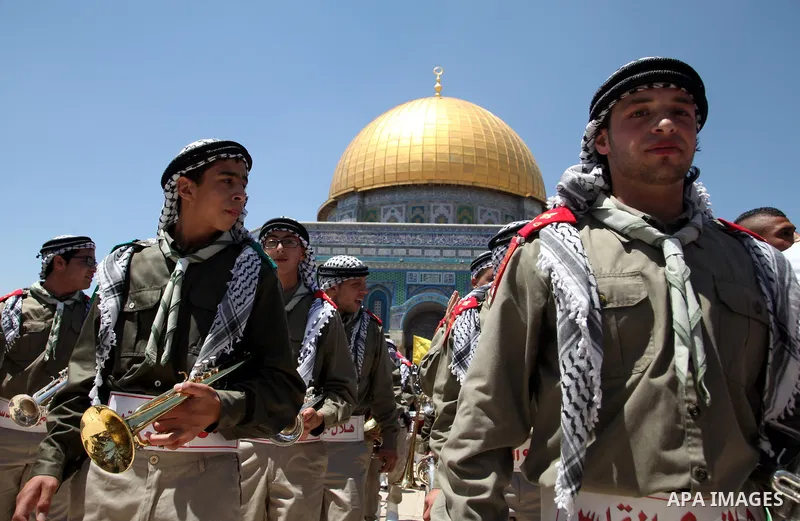 Palestinian scouts play musical instruments during a ceremony commemorating the Islamic holiday of Isra Mi'raj, outside the Dome of the Rock at the Al-Aqsa mosque compound in the Old City of Jerusalem on May 26, 2014. Ph...