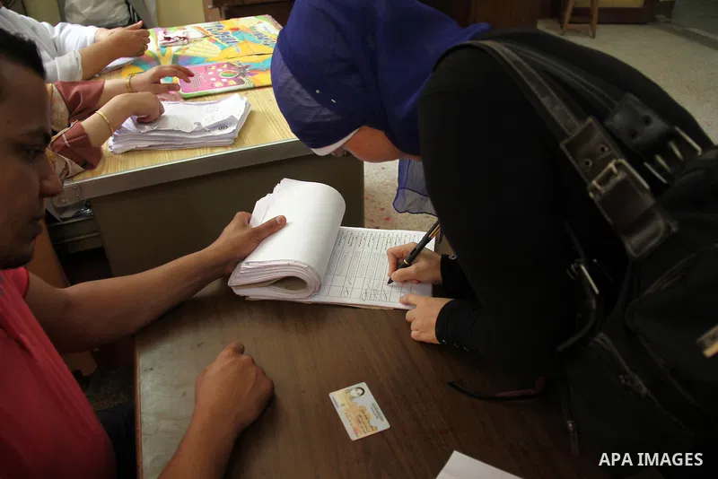 An Egyptian woman fills her ballot during the third day of voting in the presidential elections at a polling station in Cairo, Egypt, 28 May 2014. Polling stations opened on 28 May for the final day of the voting after e...