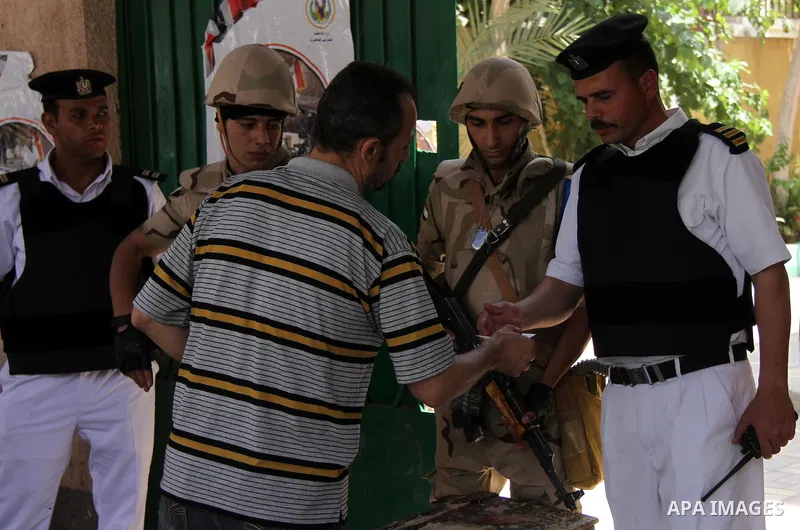 An Egyptian man shows his ID before casting his vote at a polling station in Cairo, Egypt, 28 May 2014. Polling stations opened on 28 May for the final day of the voting after election commission's decision to extend the...