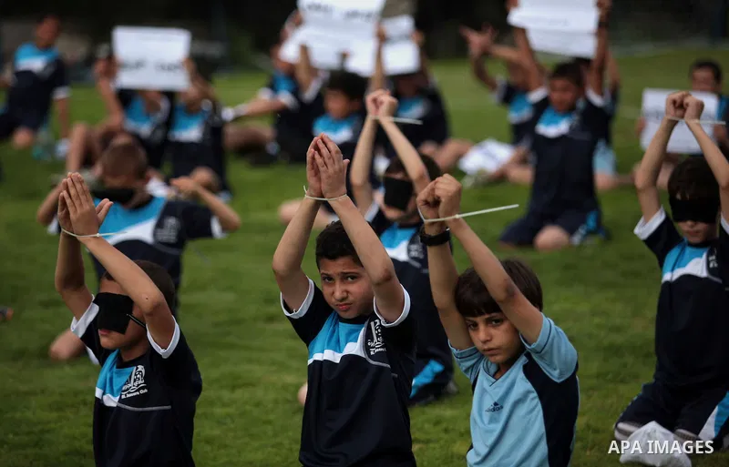 Palestinian children take part in a demonstration to show solidarity with Palestinian prisoners held in Israeli jails, in Gaza city on May 28, 2014. Some 120 Palestinians jailed without trial in Israel have been on an op...